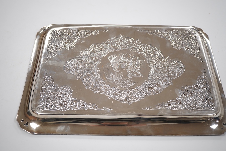 An Edwardian embossed silver dressing table tray, by Henry Matthews, Birmingham, 1901, length 32.1cm, 16.8oz.
